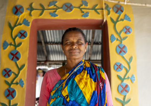 Christian woman from Santal ethnic group in front of a decorated door, Rajshahi Division, Tanore, Bangladesh
