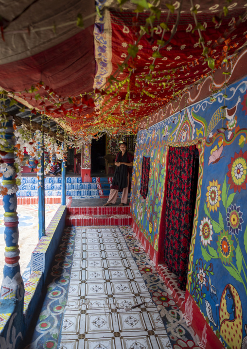 Bangladeshi woman in front of a traditional wall painting in a house, Rajshahi Division, Tikoil, Bangladesh