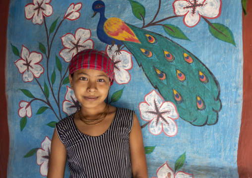 Bangladeshi girl in front of a traditional wall painting in a house, Rajshahi Division, Tikoil, Bangladesh