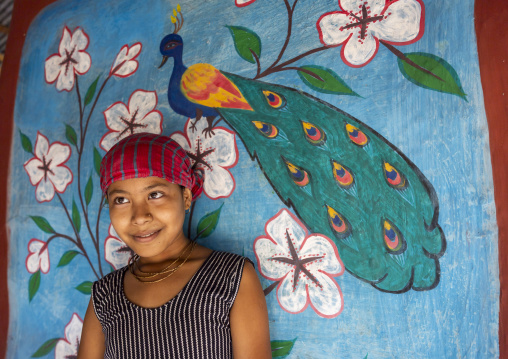 Bangladeshi girl in front of a traditional wall painting in a house, Rajshahi Division, Tikoil, Bangladesh