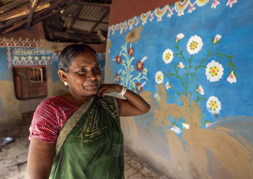 Bangladeshi woman in front of a traditional wall painting in a house, Rajshahi Division, Tikoil, Bangladesh