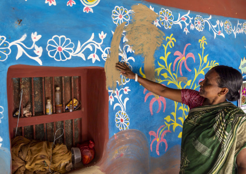 Bangladeshi woman in front of a traditional wall painting in a house, Rajshahi Division, Tikoil, Bangladesh