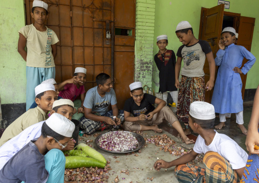 Bangladeshi muslim boys in a madrassa cooking, Rajshahi Division, Puthia, Bangladesh