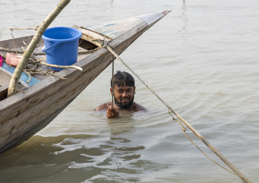 River gypsy man having a bath near his boat, Barisal Division, Barisal, Bangladesh