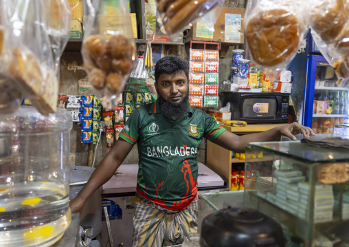 Bangladeshi man with a Bangladesh cricket team shirt in a shop, Dhaka Division, Dhaka, Bangladesh