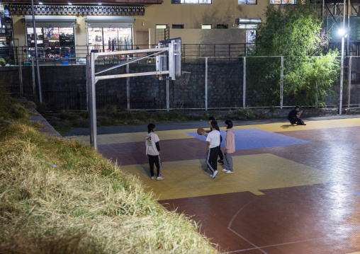 Teens playing basketball at night, Chang Gewog, Thimphu, Bhutan
