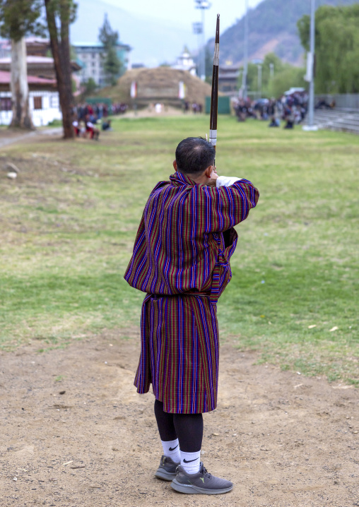 Bhutanese man aims arrow in archery competition, Chang Gewog, Thimphu, Bhutan