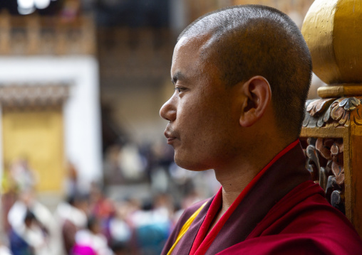 Side view portrait of a bhutanese monk in Punakha Dzong, Punakha dzongkhag, Punakha, Bhutan