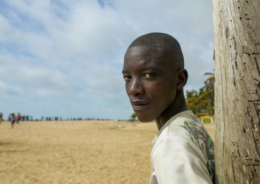 Boy with the face full of sand on the beach, Luanda Province, Sumbe, Angola