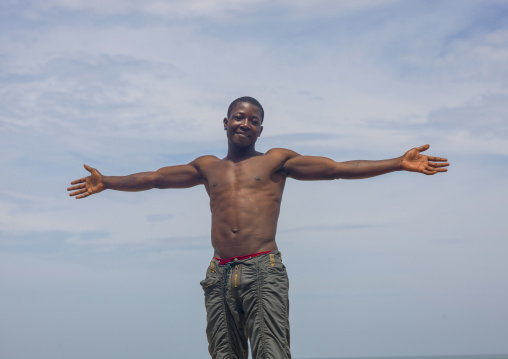 Man doing the christian cross with his arms , Benguela Province, Benguela, Angola