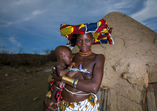 Mucubal tribe woman holding her baby, Namibe Province, Virei, Angola