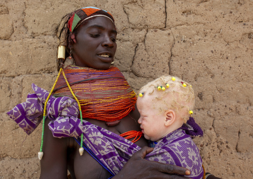 Mwila tribe mother with her albino toddler, Huila Province, Chibia, Angola