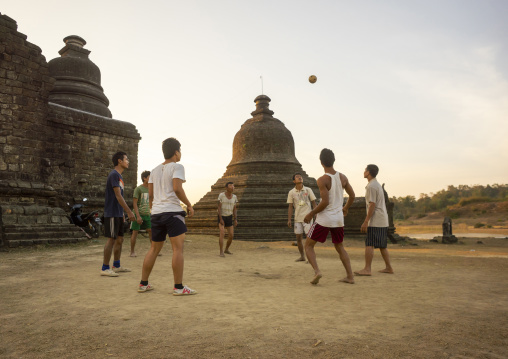 Men playing chinlone in front of stupas, Rakhine state, Mrauk U, Myanmar