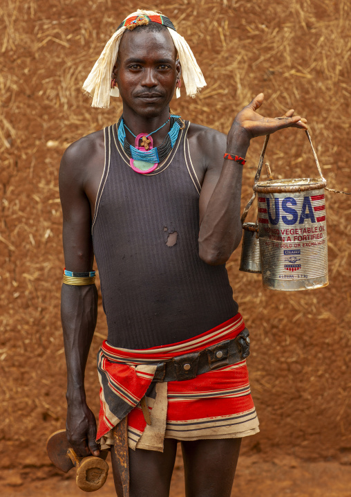 Tsemay tribe man with a US aid can, Omo Valley, Key Afer, Ethiopia