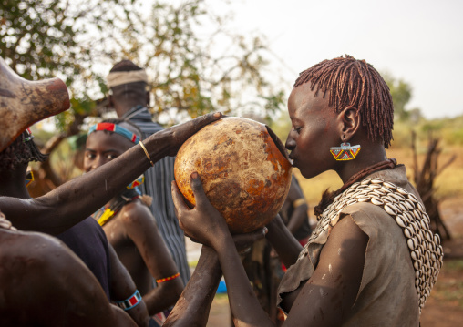 Banna woman drinking from calabash during bull jumping, Omo valley, Turmi, Ethiopia