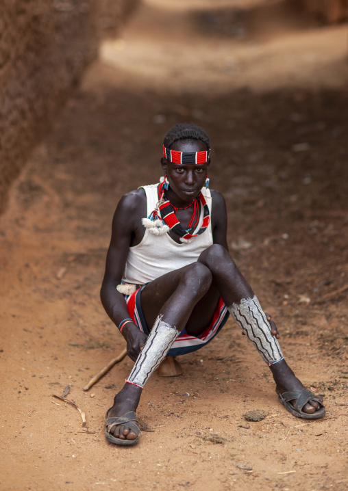 Hamer young man sitting in a street, Omo valley, Turmi, Ethiopia