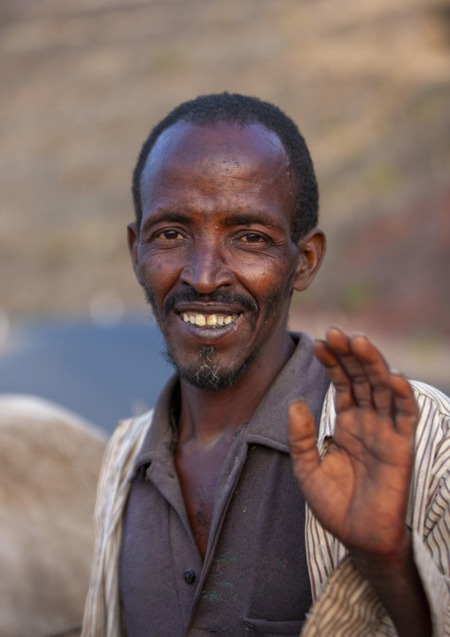 Portrait of a smiling man waving at camera, Dire Dawa woreda, Dire Dawa, Ethiopia