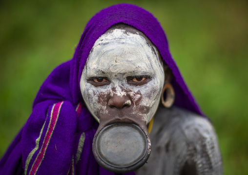 Young suri woman with lip plate and painted face, Kibbish, Omo valley, Ethiopia