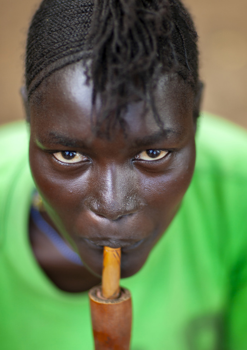 Anuak tribe woman smoking pipe, Dima, Gambela province, Ethiopia