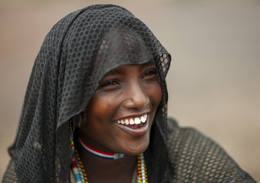Portrait of a smiling Karrayyu young woman, Oromia, Metahara, Ethiopia