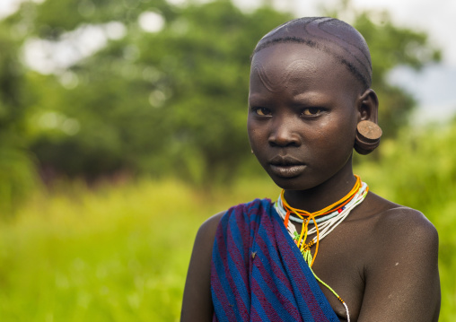 Surma girl with scarifications and enlarged ears, Omo valley, Kibish, Ethiopia