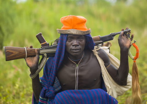 Portrait of a Surma man with a kalashnikov, Omo valley, Kibish, Ethiopia