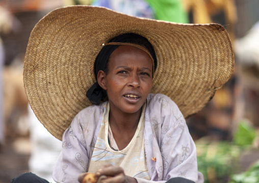 Oromo woman with a huge hat in market, Oromia, Woliso, Ethiopia
