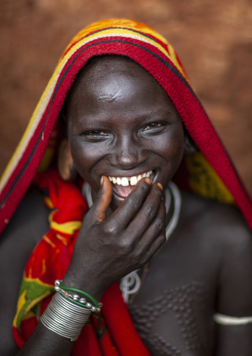 Smiling suri tribe woman with traditional scarifications, Kibish, Omo valley, Ethiopia