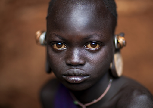 Suri tribe girl with enlarged earlobes, Kibish, Omo valley, Ethiopia