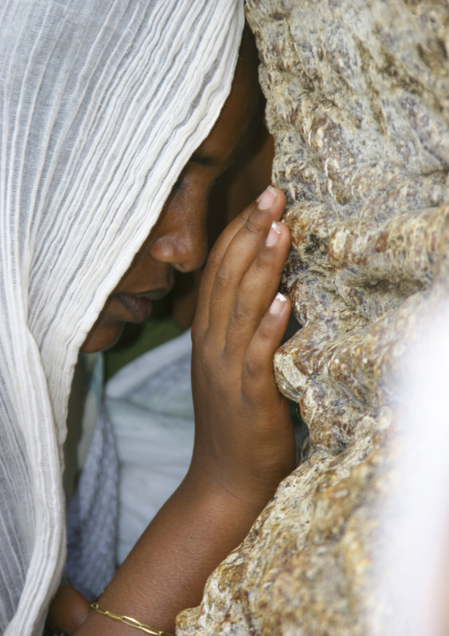 Woman praying on the baobab during festival of mariam dearit, Anseba, Keren, Eritrea