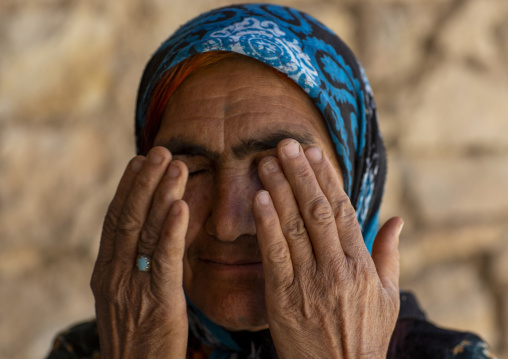 Old kurdish woman with her fingers on her eyes, Kordestan province, Palangan, iran