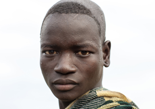 Portrait of a Bodi tribe man with shaved head, Hana Mursi, Omo valley, Ethiopia