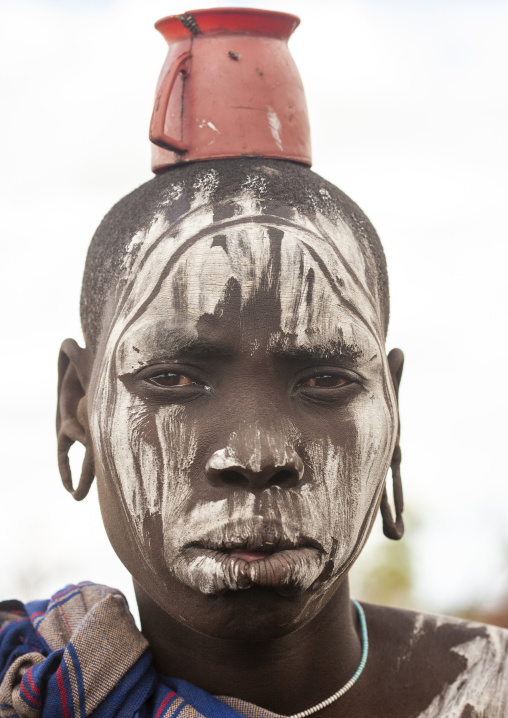 Mursi tribe woman with a cup on her head, Mago national park, Omo valley, Ethiopia