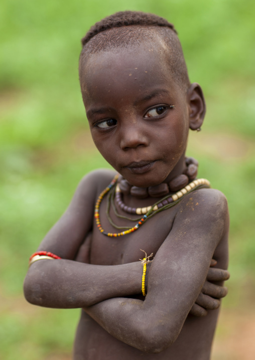 Serious Hamer tribe kid with 50 cent chain, Turmi, Omo valley, Ethiopia