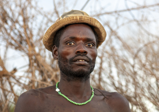 Portrait of a nyangatom tribe man wearing a hat, Omo valley, Murile, Ethiopia