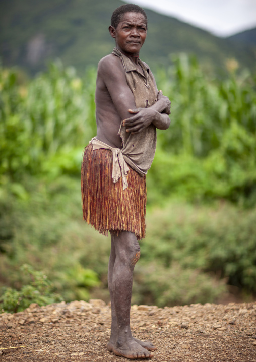 Portrait of an old Ari tribe woman with traditional vegetal skirt, Ari zone, Jinka, Ethiopia