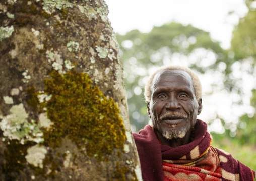 Old man in front of phallic shaped steles, South Ethiopia Regional State, Gedeo, Ethiopia