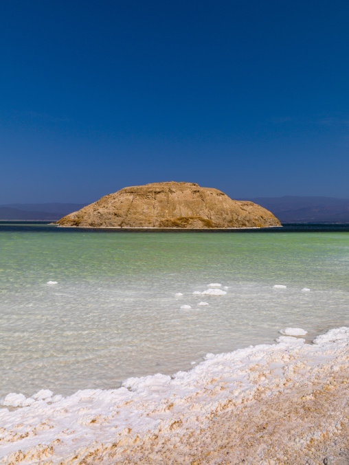 The Devil's Cauldron rock formation rises from turquoise water ringed by white salt, Dikhil Region, Lake Assal, Djibouti
