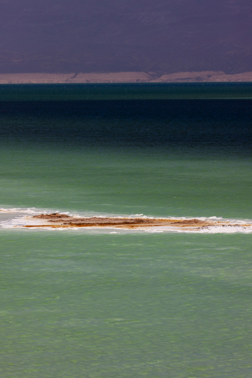 A narrow salt sandbar breaks the color gradient of Lake Assal's water, Dikhil Region, Lake Assal, Djibouti