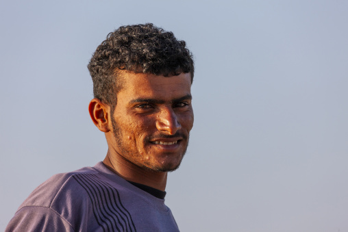 A smiling yemeni man poses against a clear sky, Obock Region, Gorodia, Djibouti