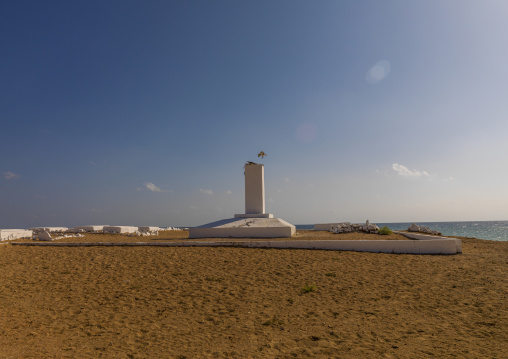 A white obelisk memorial stands in a French colonial marine cemetery by the sea, Obock Region, Obock, Djibouti