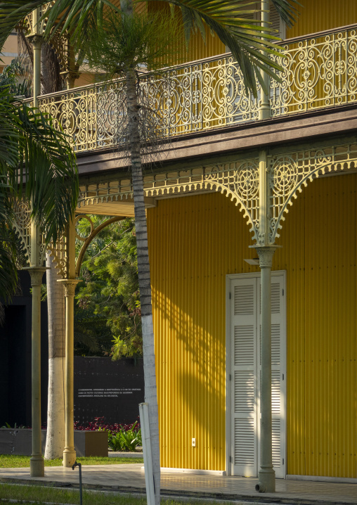 Ornate wrought-iron balcony of the Palacio de Ferro framed by a palm tree, Luanda Province, Luanda, Angola