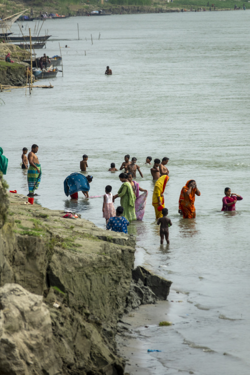 Villagers bathing and washing clothes in the river, Dhaka Divisi