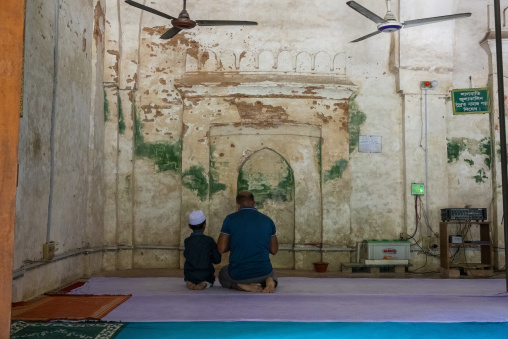 Father and son praying inside Qasba Mosque, Barisal Division, Gournadi, Bangladesh