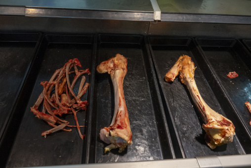 Animal bones are displayed in metal trays at a market stall, Gansu Province, Linxia, China