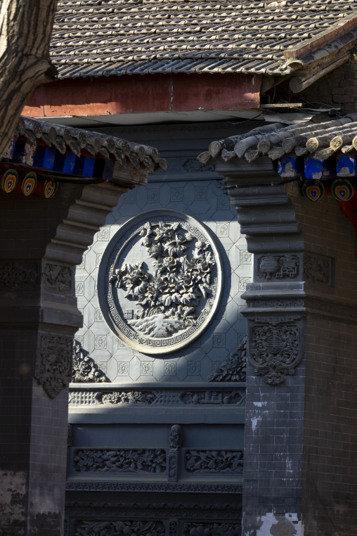 Carved stone relief decorates a gable at Dong Gong Guan mansion, Gansu Province, Linxia, China
