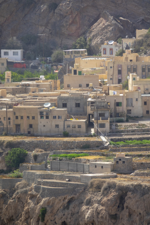 Cluster of traditional and modern houses built into a rocky hillside, Jebel Akhdar, Sayq, Oman