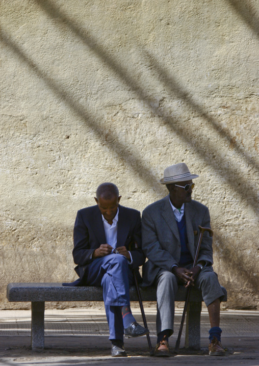 Two old eritrean men sitting on a bench, Central Region, Asmara, Eritrea