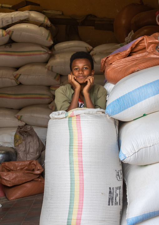 Eritrean boy in a warehouse full of grains bags, Central region, Asmara, Eritrea