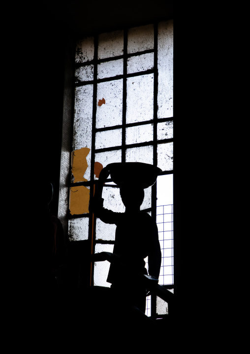 Eritrean boy in an old art deco style stairs from the italian colonial times, Central region, Asmara, Eritrea